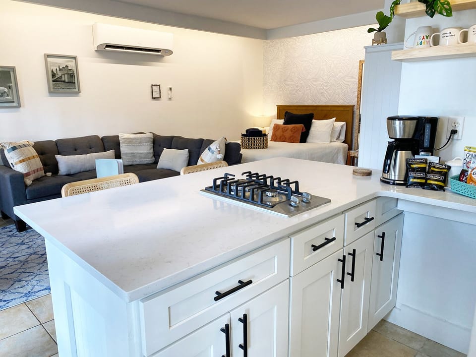 Kitchen overlooking downstairs L-shaped couch & queen bed.