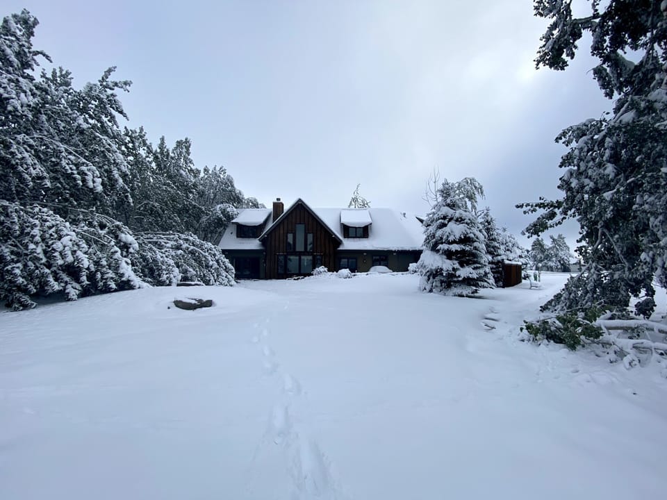 Back of house in winter with deep snow
