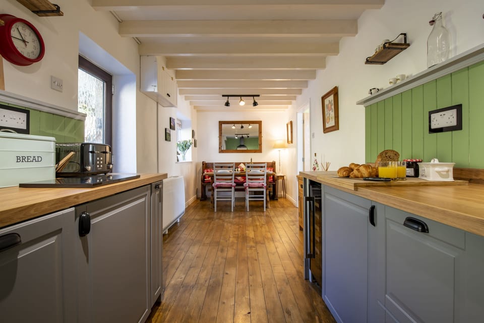 Ground floor: Dining kitchen with rear door leading out to the patio area