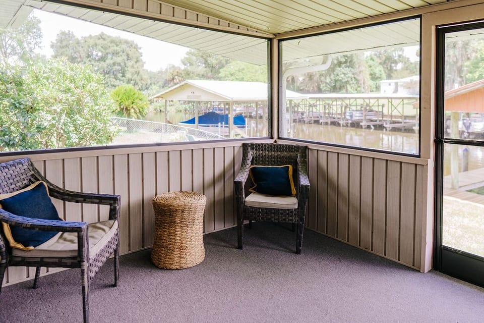 Screened in back porch with a water view 
