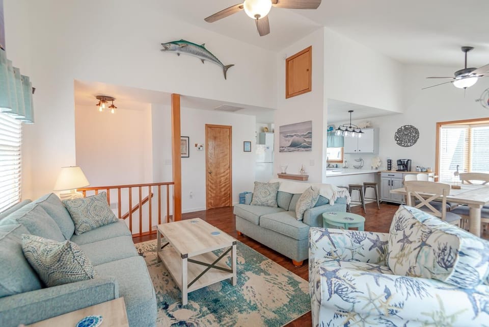Reverse floor plan with kitchen, dining, and living areas on top floor