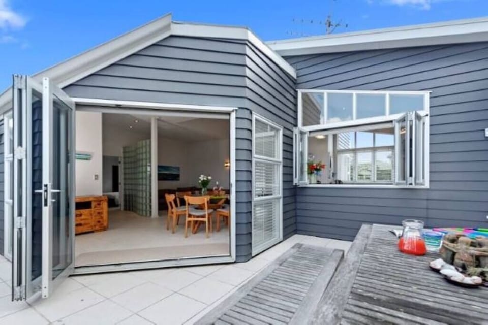 Outdoor dining area with servery from kitchen and bi-fold doors from upstairs living/dining.
