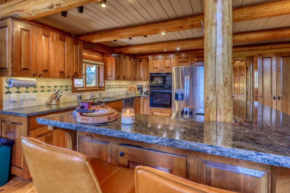 Beautiful designer kitchen opens up to the dining and living space & has a gas grill and outdoor dining. Fantastic layout for family & friends.