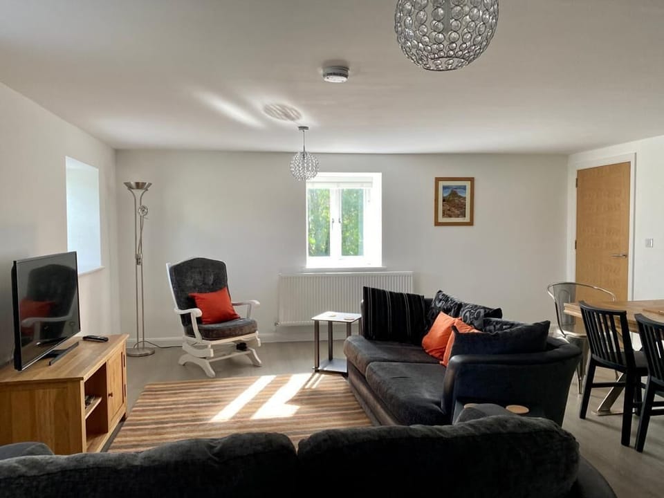 Our living area includes sofas, chairs, large TV, dining table and great views.