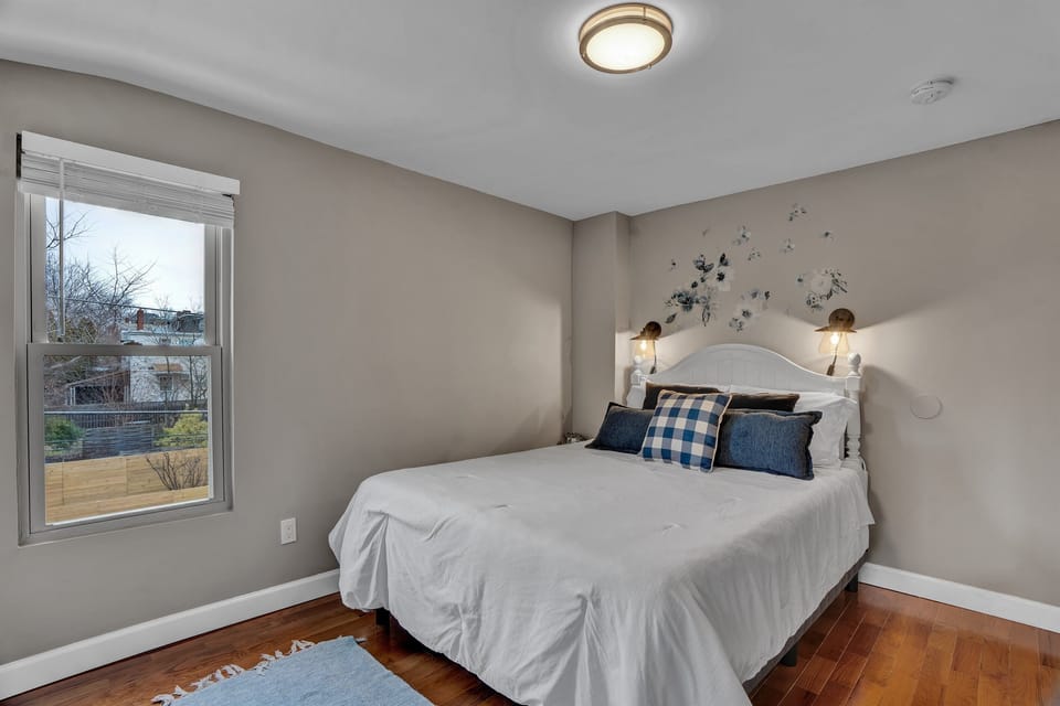 The left-side bedroom, bathed in soothing tones, presents a harmonious blend of comfort and simplicity. The queen-sized bed invites relaxation and tranquility