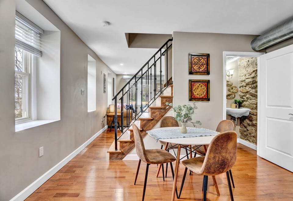 The dining room has a dining room table for shared meals and conversations. The standout feature of the room is the abundance of natural light that floods in through the large windows