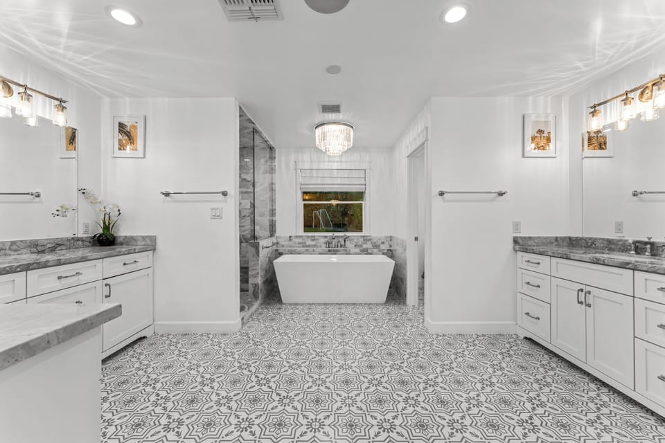 Bright, modern & made for unwinding, tub, sleek sinks & roomy shower.