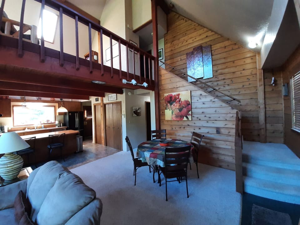 Dining area and stairs leading to upper loft and master bedroom and bath