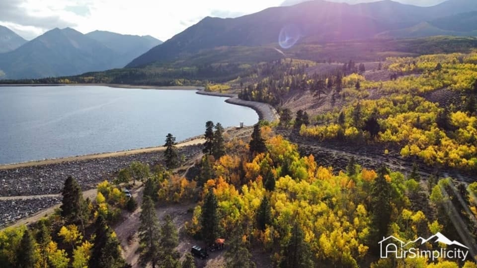 The crystal clear waters of Twin Lakes are surrounded by a sea of colorful autumn foliage in this aerial shot. Photo credit: Jake Jarvis