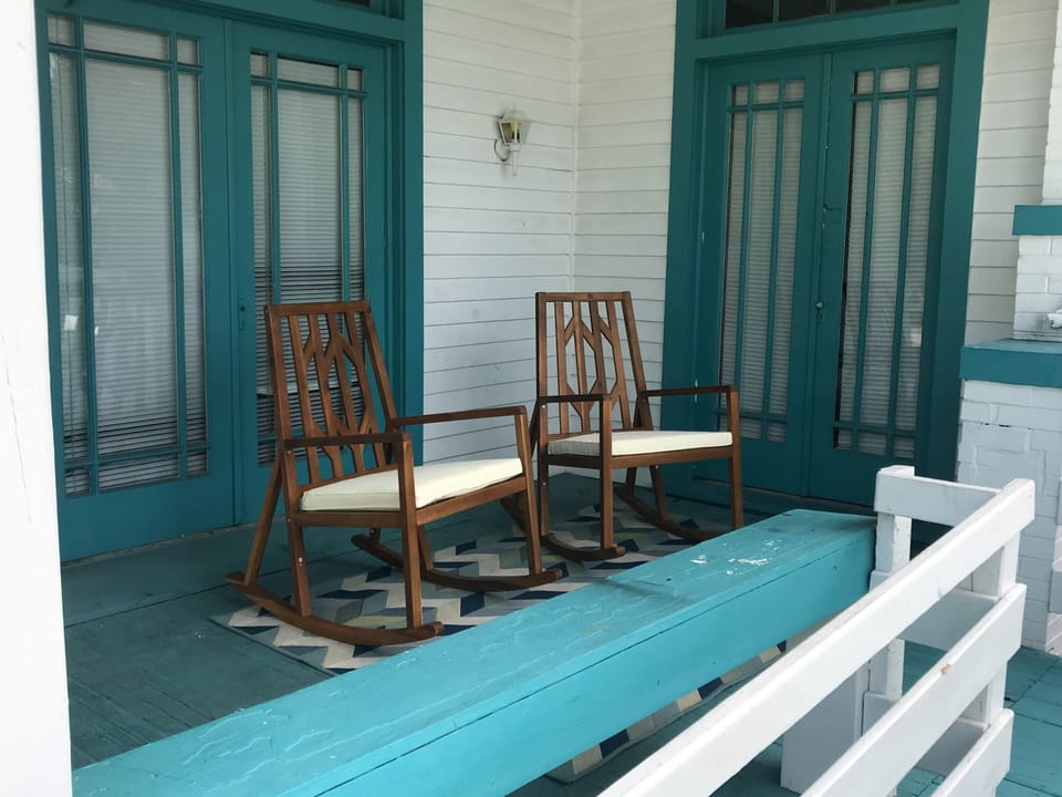 Side porch with two rocking chairs