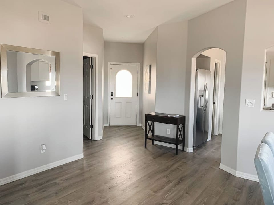 View from living room toward the welcoming front entry and open hallway