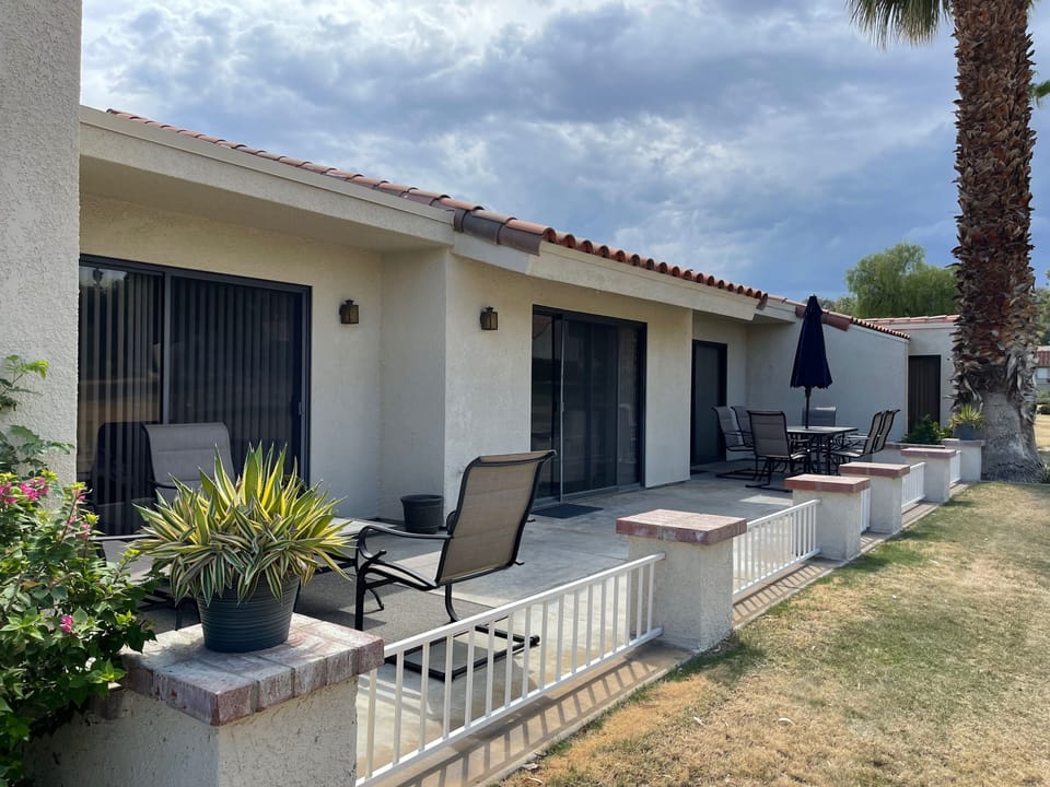 Large patio with conversation area and dining area