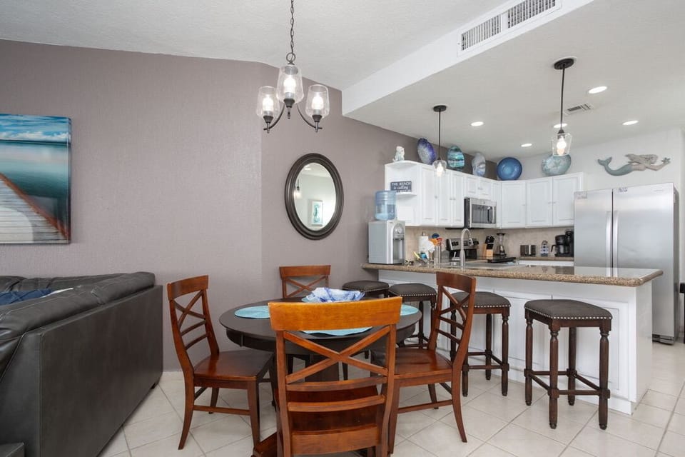 Plenty of room for everyone! The dining area includes 4 chairs and 4 stools.