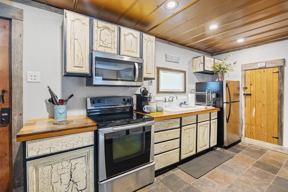 Cook like a pro in our fully equipped upper-level kitchen! Featuring a Keurig, microwave, oven, range, and plenty of storage for all your culinary needs.  You can also enjoy easy access to one of our 2 full size bathrooms on this level.