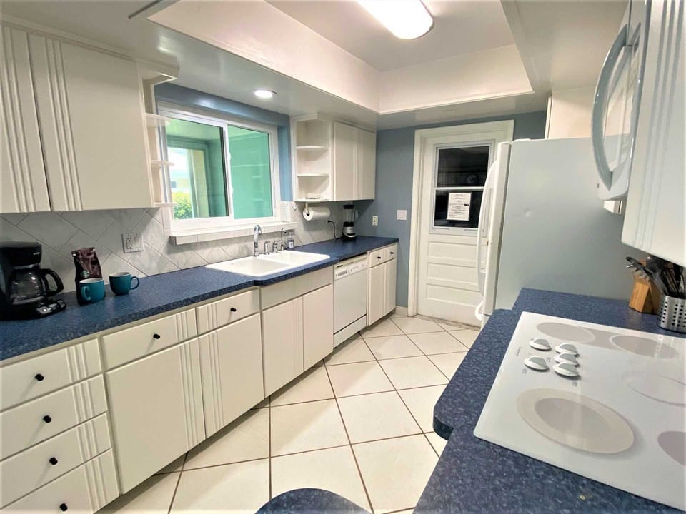 Fully equipped kitchen has all appliances, dishes, cookware and spice cupboard.