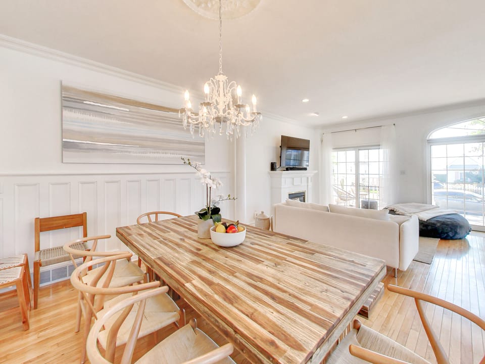 Acacia wood dining table with Wishbone chairs - views of the water as you dine