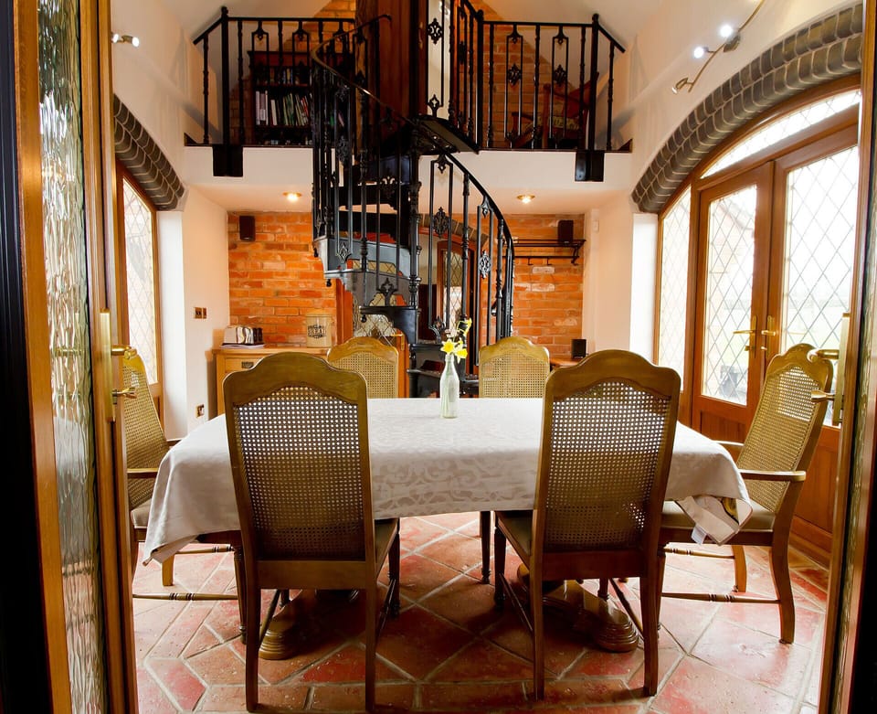 Coach House dining area spiral stair case leading to en-suite bedroom