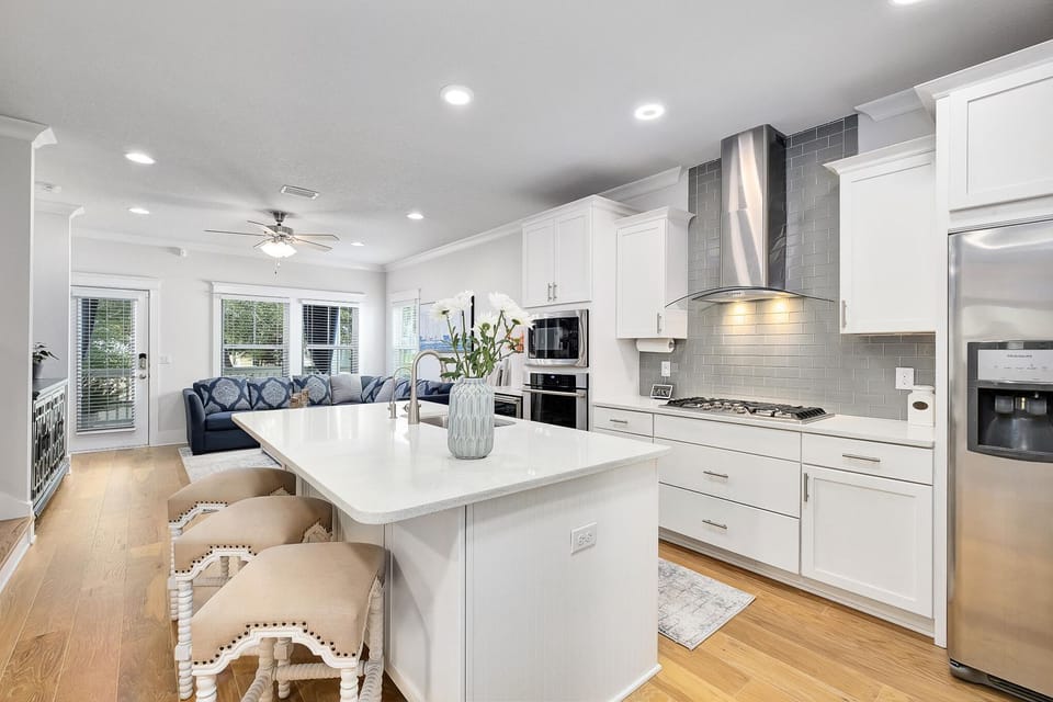 open concept living room/kitchen with stainless steel appliances