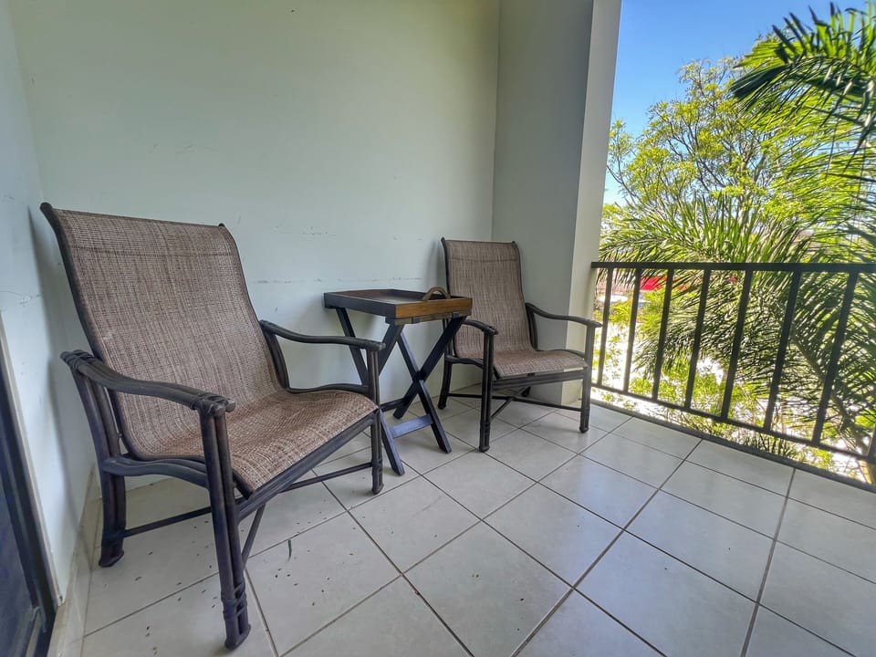 Extra patio chairs expand the balcony seating area.