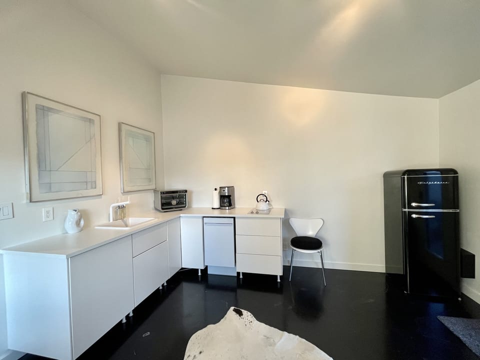 Kitchen has retro, apartment size refrigerator.