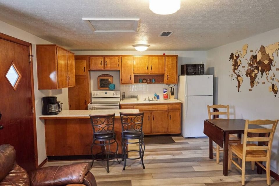 Plenty of seating for home cooked meals with a small dining table and kitchen counter stools