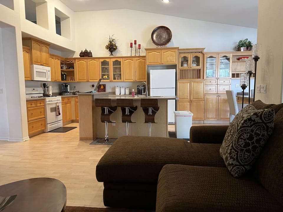View from the informal living room to spacious kitchen where memories are made. 
