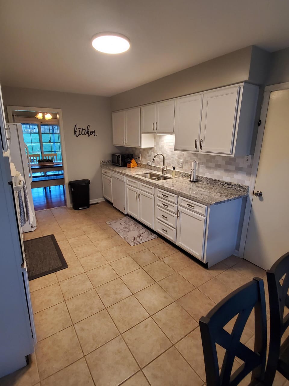 Clean and modern kitchen with stainless sink, full-size appliances, and ample counter space at Andrea Abode in Lexington, Kentucky — just minutes from local attractions.