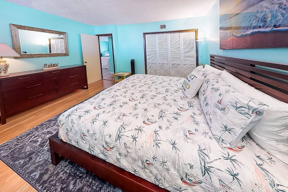 Pretty beach blue King master bedroom with dresser & a closet.
