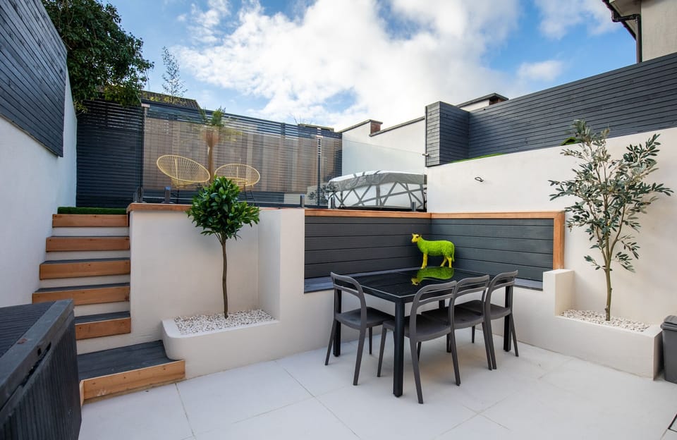 Outdoor area with hot tub and dining area