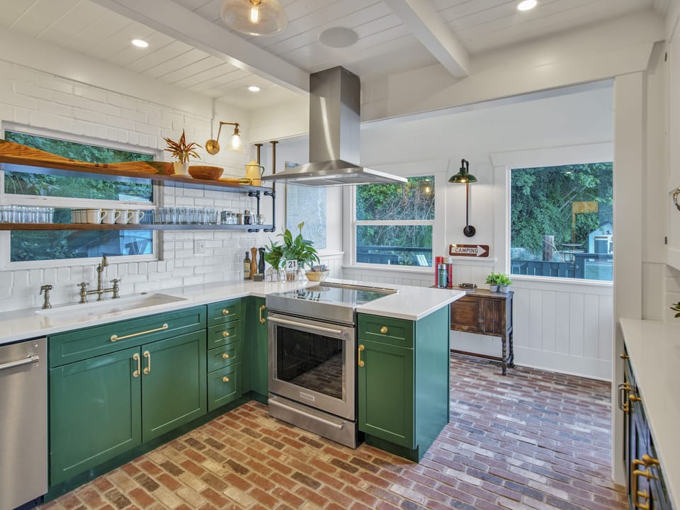 Beautiful kitchen stocked with lobster pot, pans, dutch oven and kitchen tools. 