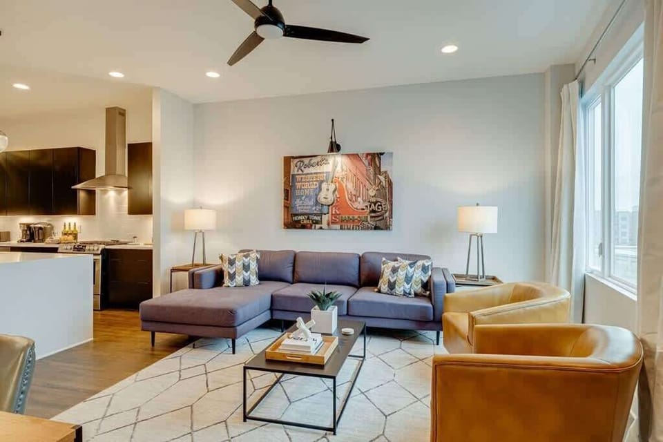 Enjoy a bright living room filled with natural light and inviting seating, perfect for relaxing and gathering together.