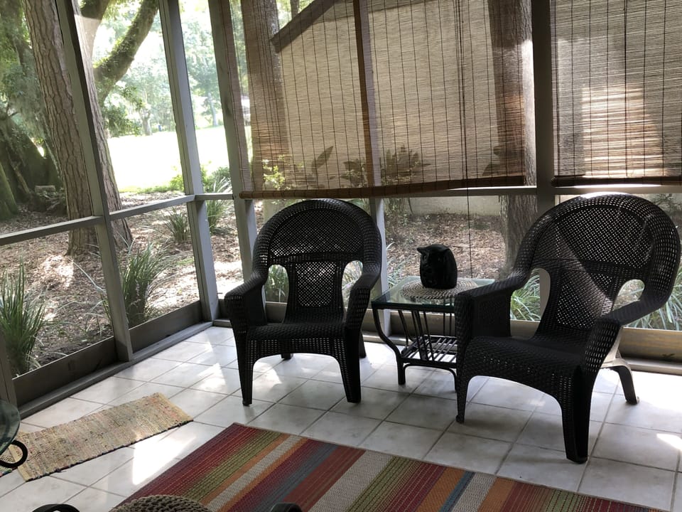 Screen Porch with couch/Chairs/Ceiling Fan and access to gas grill and views