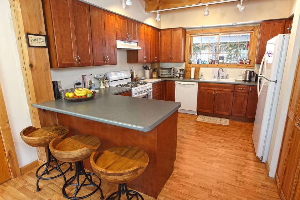 Kitchen filled with all the essential spices, air fryer, milk frother, & coffee.