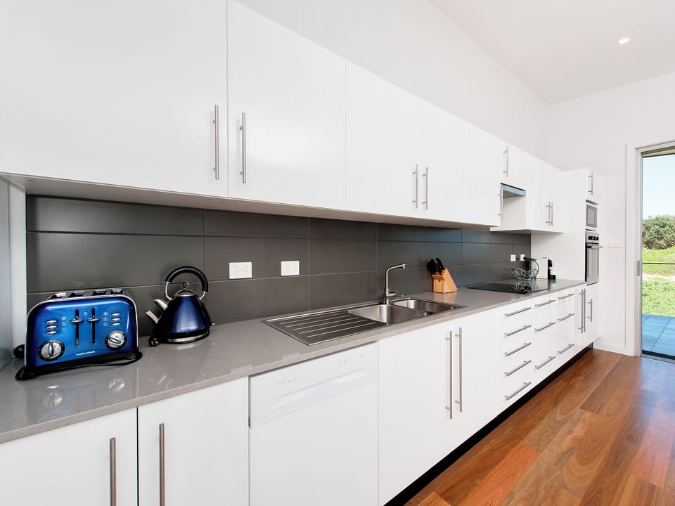 Bright modern kitchen with ample storage and generous prep space