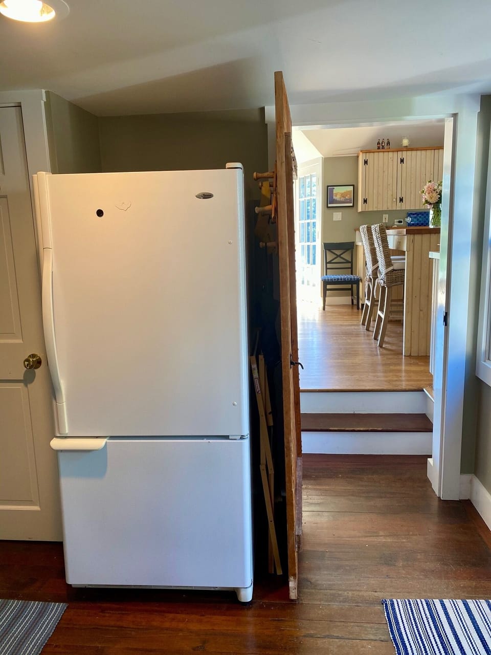 Extra fridge and entryway into kitchen