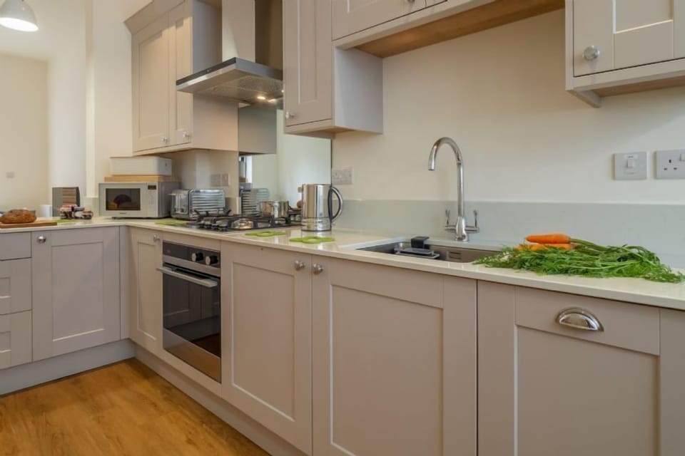 Ground floor: Kitchen with Nespresso coffee machine, electric oven and gas hob, microwave, dishwasher, fridge-freezer and washing machine