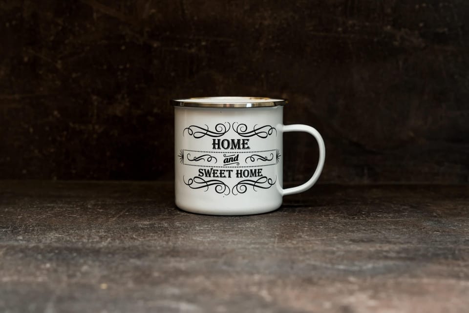 A close-up of a decorative coffee mug placed on a wooden surface, adding a personal touch.
