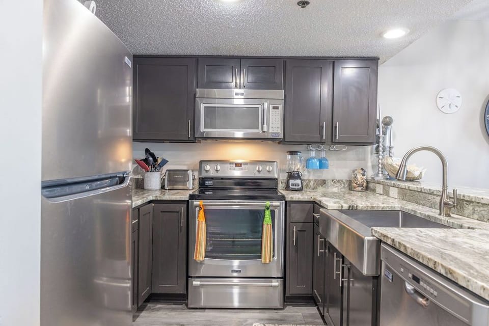 Kitchen - The spacious kitchen features both small and large appliances and is fully stocked with all items needed for preparing meals during your stay.