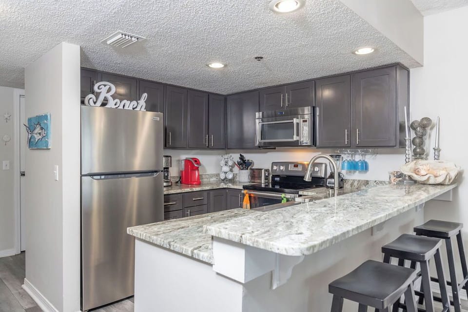Kitchen - The kitchen features an eat-in style bar. Perfect for setting up your meals buffet style, or seating for additional guests.