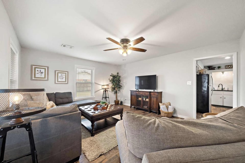 Living Room: Bright and inviting space with plush seating, perfect for lively gatherings.