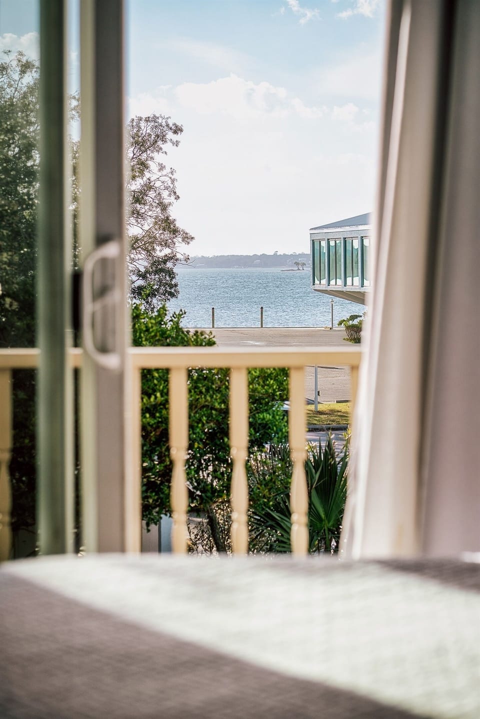 Step out and enjoy a glimpse of the water right from your downstairs primary room.