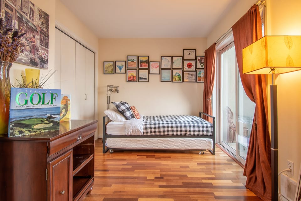 Second bedroom with comfortable twin trundle beds, cozy balcony w/ city views