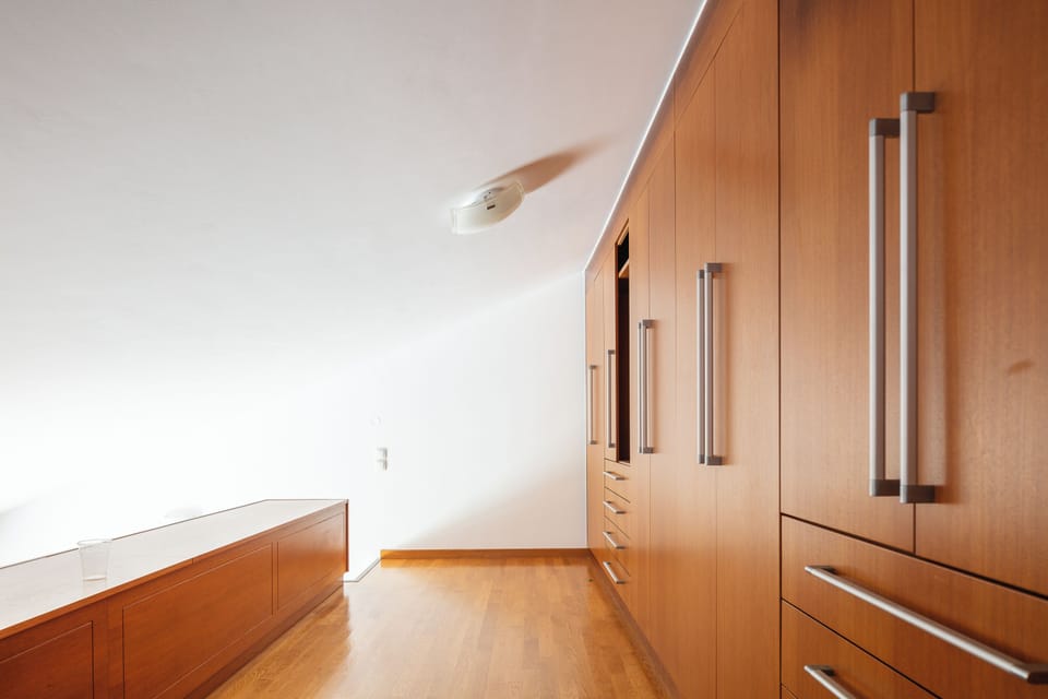 The well sized bedroom features a King size bed, soft armchair and a big wardrobe.