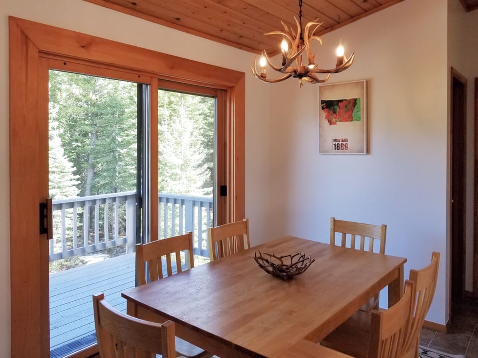 Dining room opens to rear deck, forest views. 