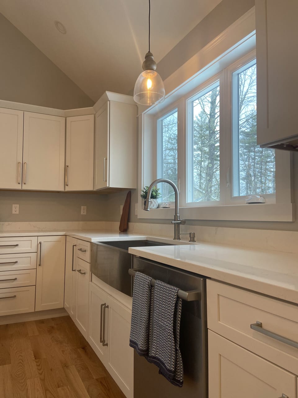 Kitchen with island seating for four and Bosch stainless steel appliances.
