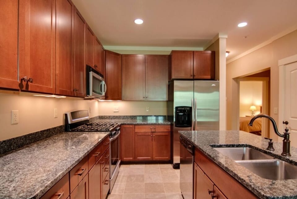The kitchen is stocked with basic cooking utensils and dishware.
