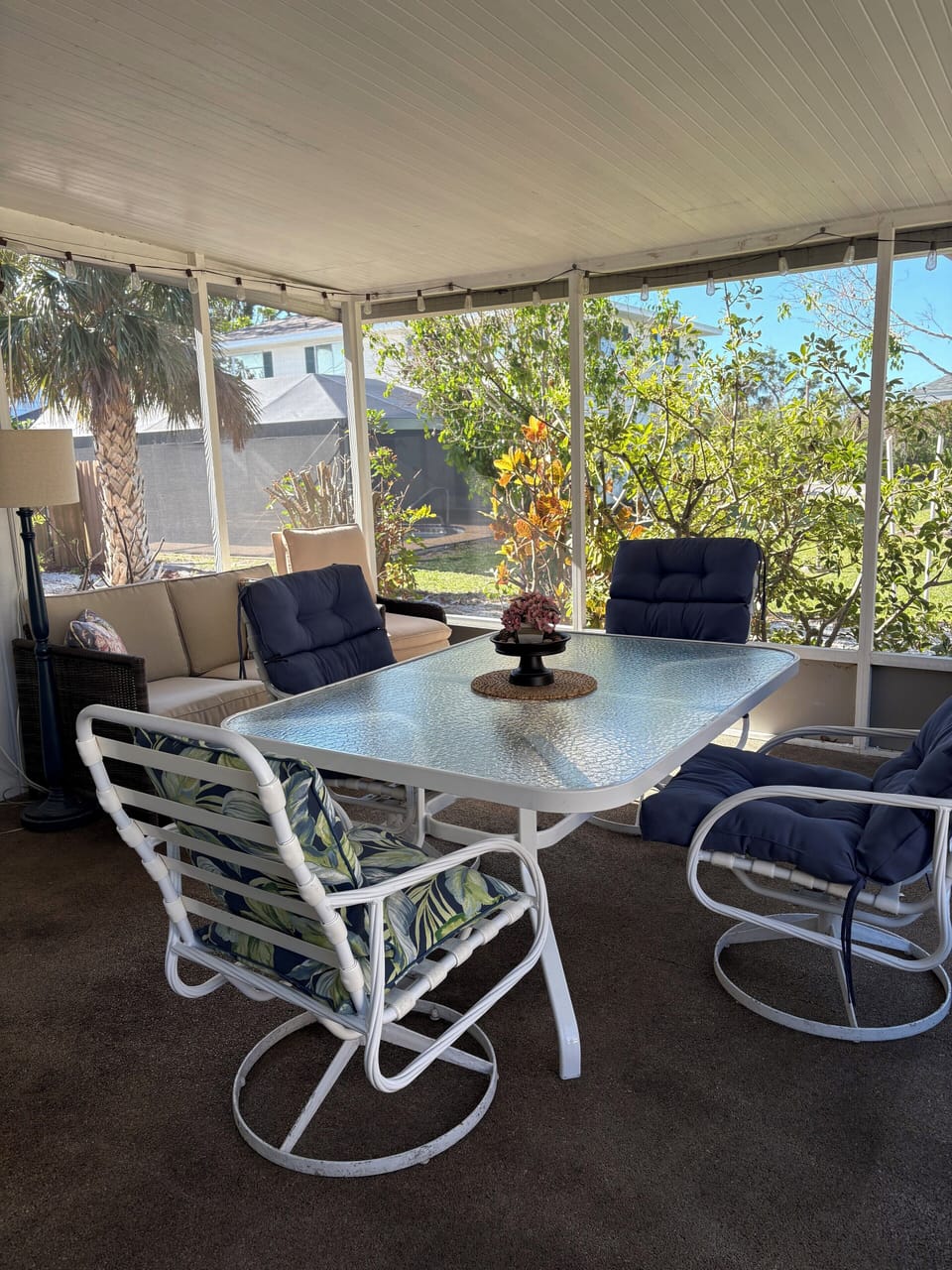 back lanai with comfortable love seat and dining area.  Enjoy evening dining 
