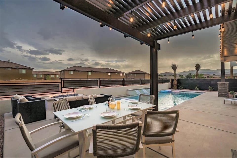 Poolside back patio dining area with pergola and views