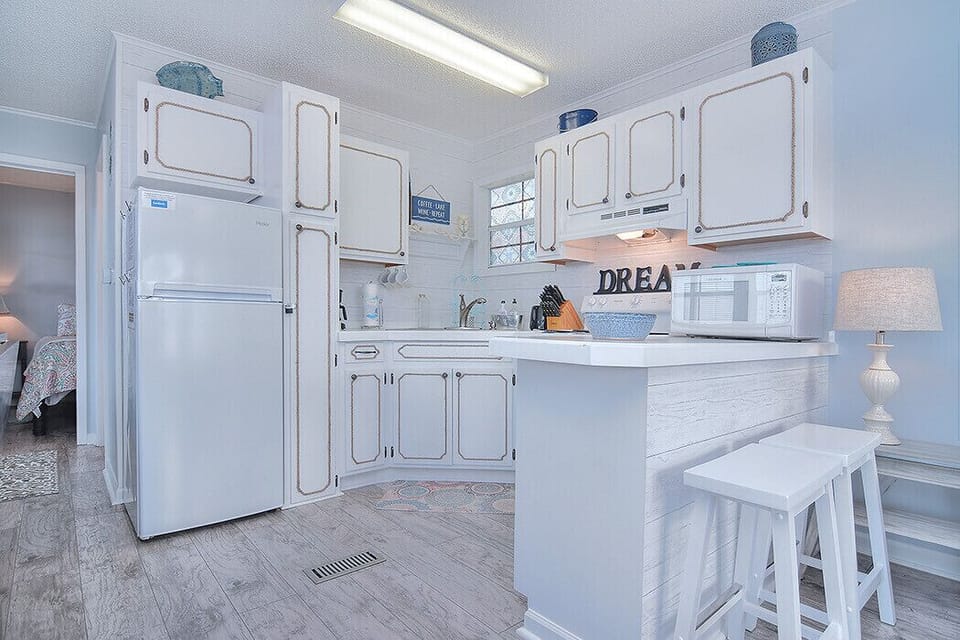 Coffee maker, toaster and microwave. Bar stool seating for two