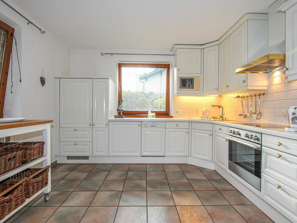 Property, Cabinetry, Countertop, Wood, Kitchen Stove, Kitchen Appliance, Interior Design, Wood Stain, Building, Flooring